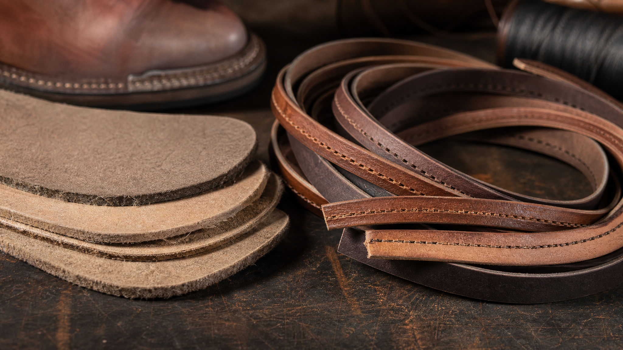 Leather welt strips and fiber insole boards on a workbench
